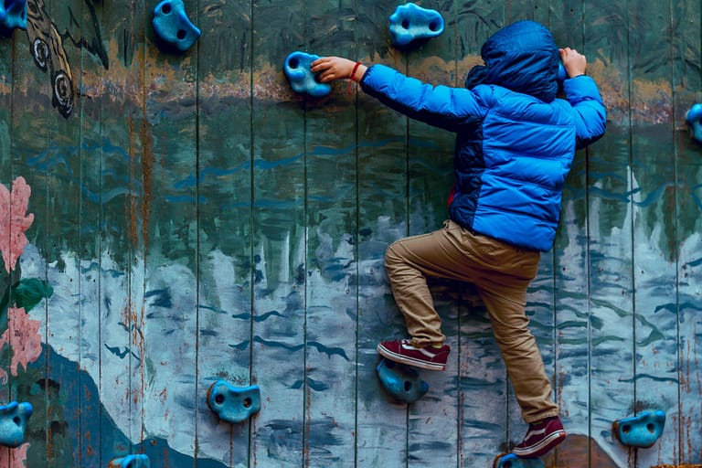 Kid rock climbing on a wall
