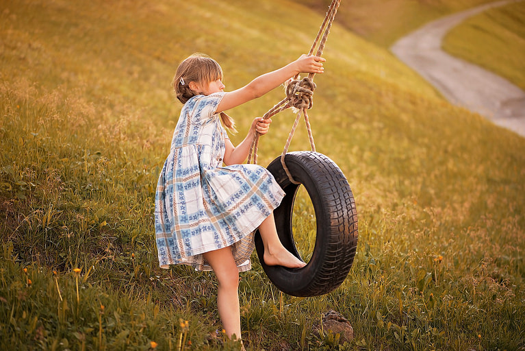 Girl on a tire swing