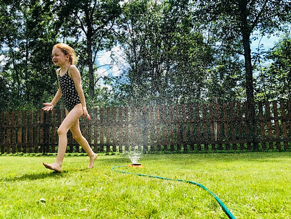 child playing in garden